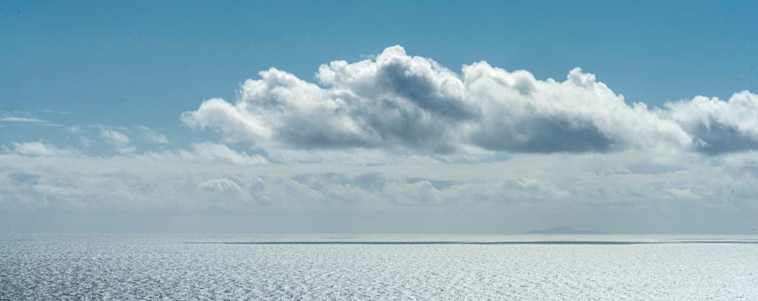 Ocean with Clouds and Sky Above It