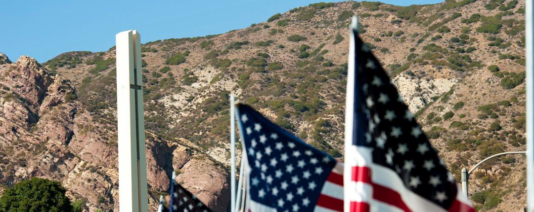 American flags with Theme Tower at Pepperdine University in the background