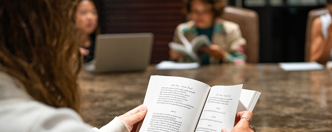 Students reading books at a table