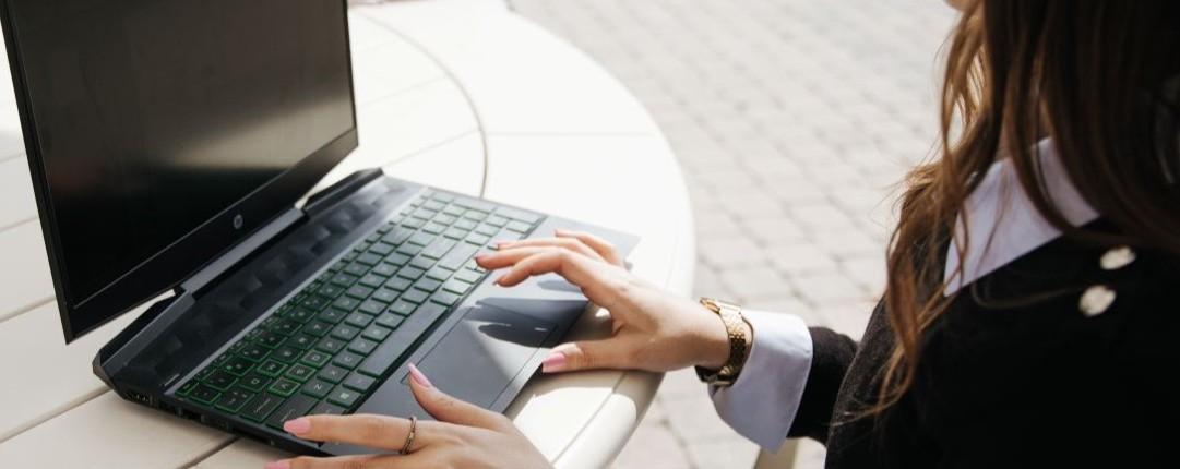 Person sitting at laptop.